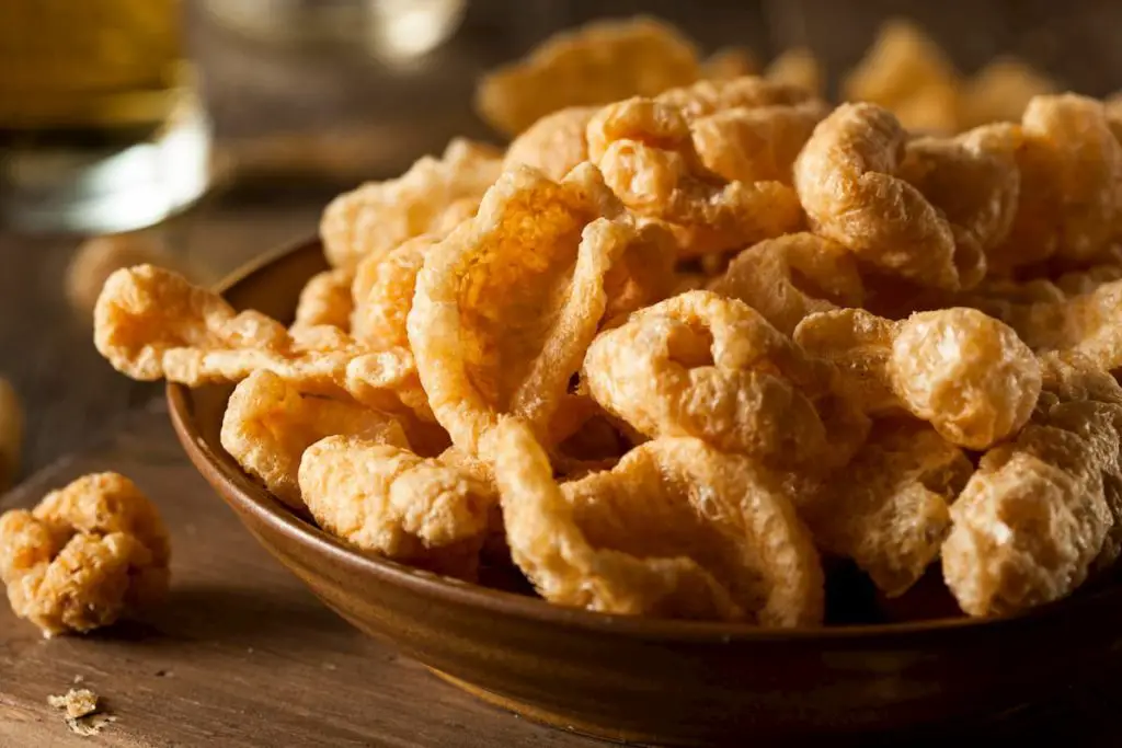 Pork rinds on a table in a bowl for snacking - Pork Rinds on Carnivore Diets